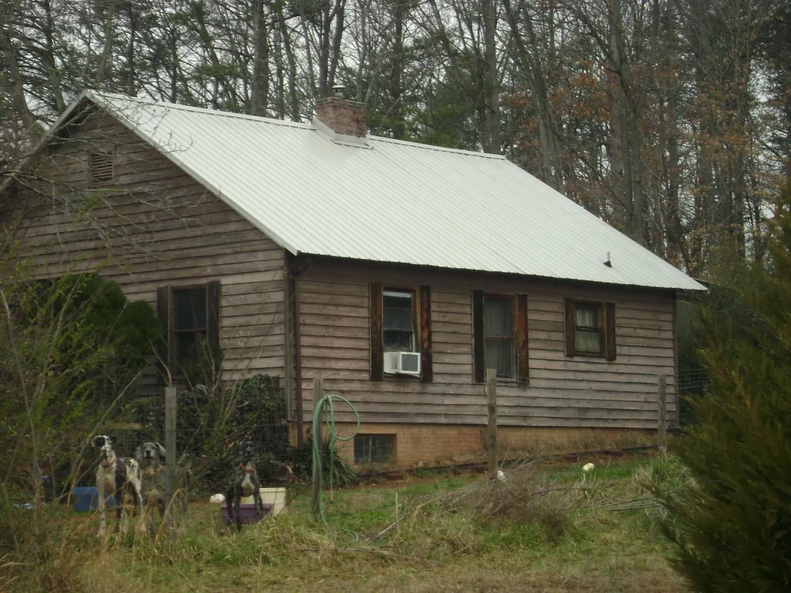 White metal roof on an old wood sided farmhouse, from a Metal Roof Installation job in Kewanna
